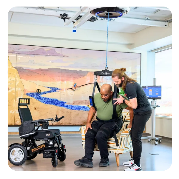 Patient rising from a chair with constant support