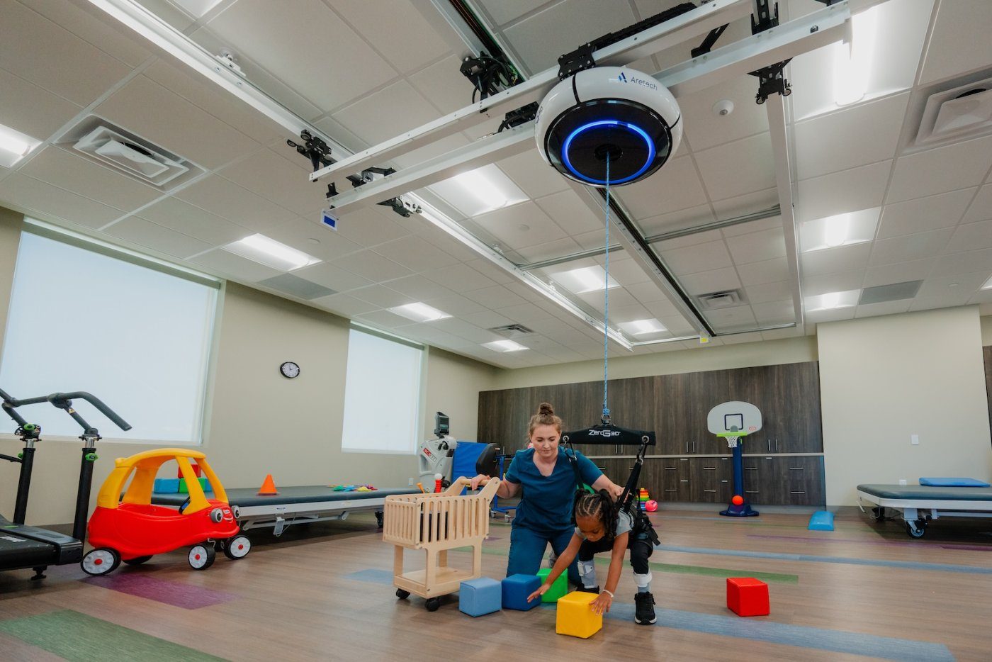 A child reaching for blocks during ZeroG 3D play therapy with a clinician