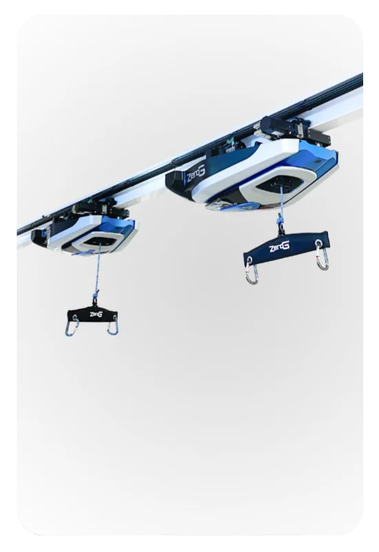 Two ZeroG robots on a shared overhead track in the same workspace