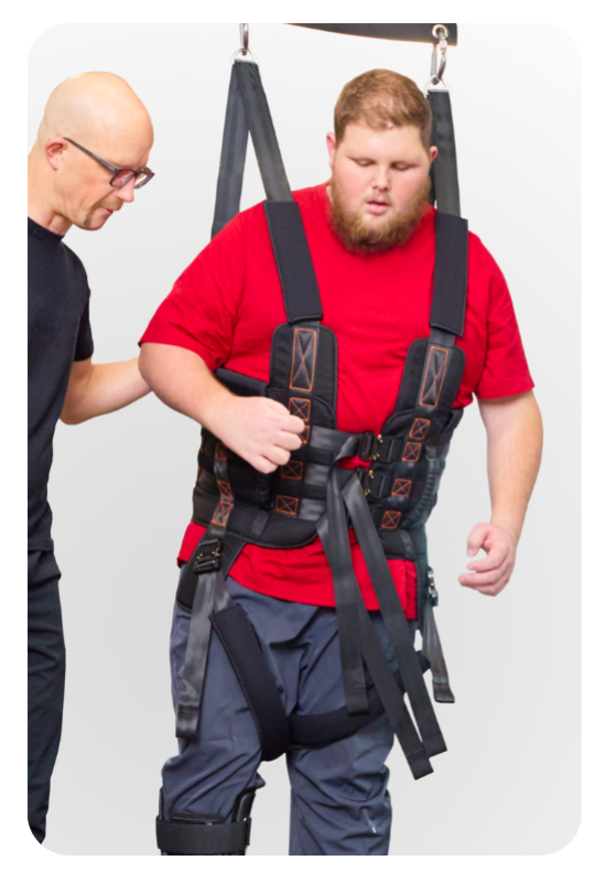 Therapist fitting a patient into the Ovation bariatric harness
